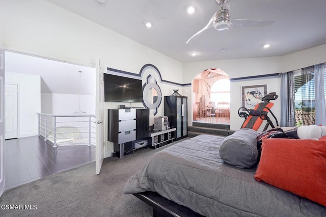 carpeted bedroom with multiple windows and ceiling fan