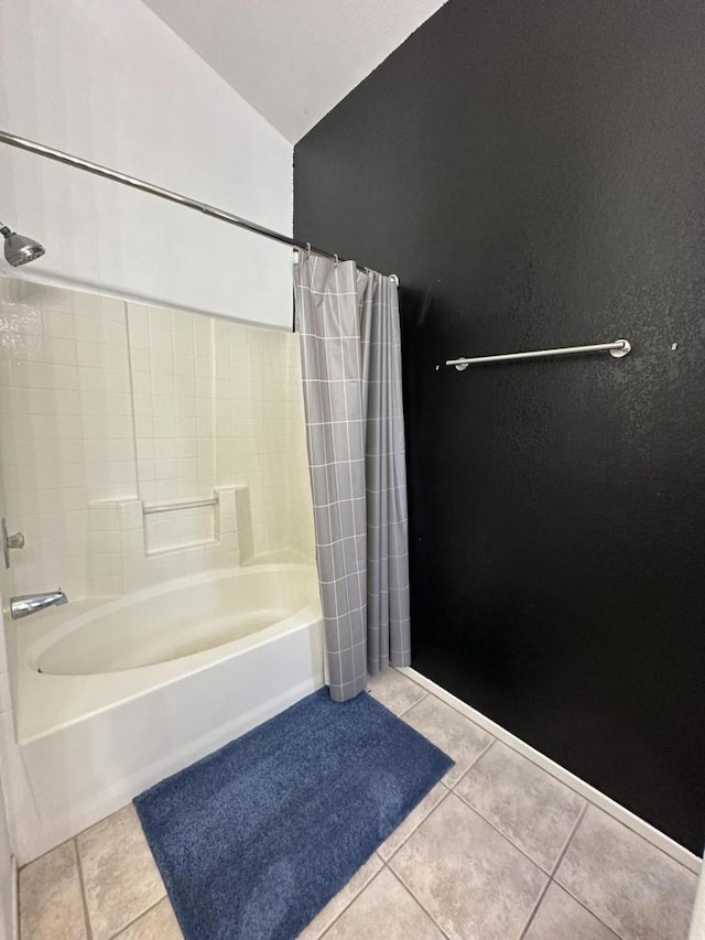 bathroom with tile patterned floors, lofted ceiling, and shower / bath combination with curtain