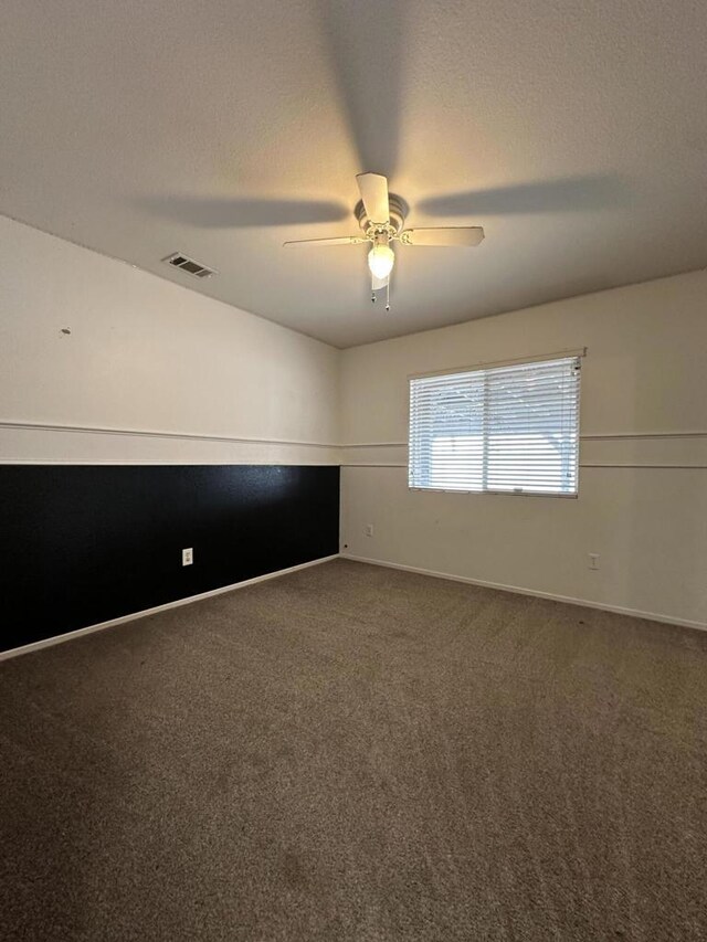 unfurnished room with ceiling fan, a textured ceiling, and carpet flooring