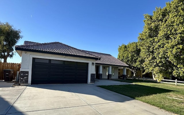 view of front of property with a garage and a front lawn