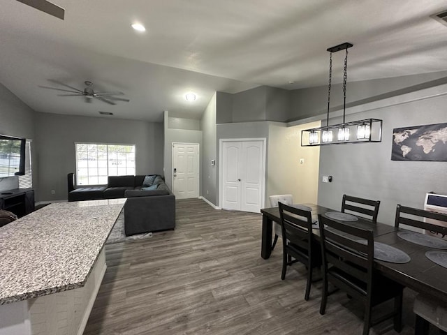 dining room featuring ceiling fan, lofted ceiling, and dark hardwood / wood-style floors