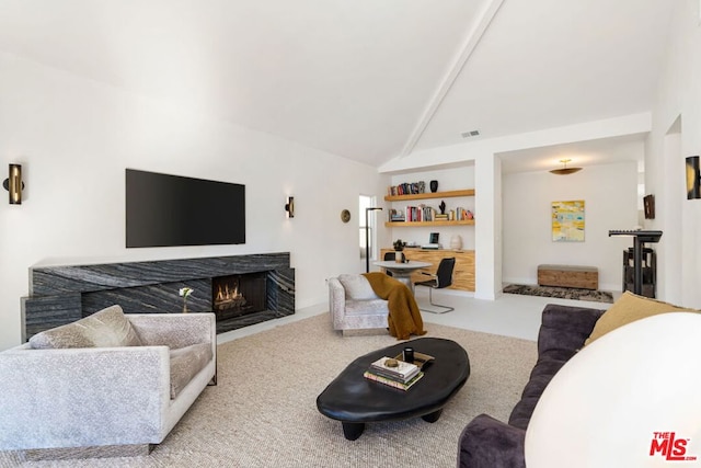 living room featuring a high end fireplace, light colored carpet, and lofted ceiling