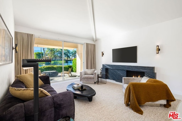 carpeted living room featuring beam ceiling