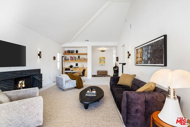 carpeted living room with high vaulted ceiling