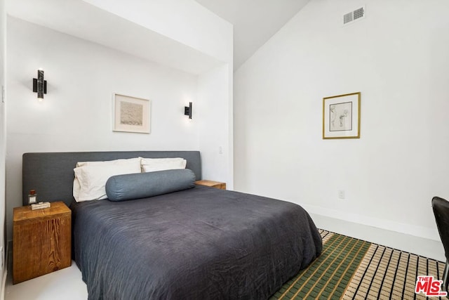 bedroom with carpet flooring and lofted ceiling