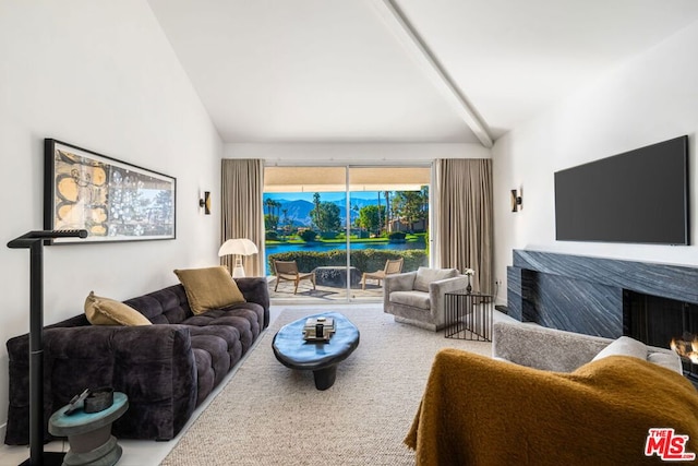 living room featuring vaulted ceiling with beams and carpet floors