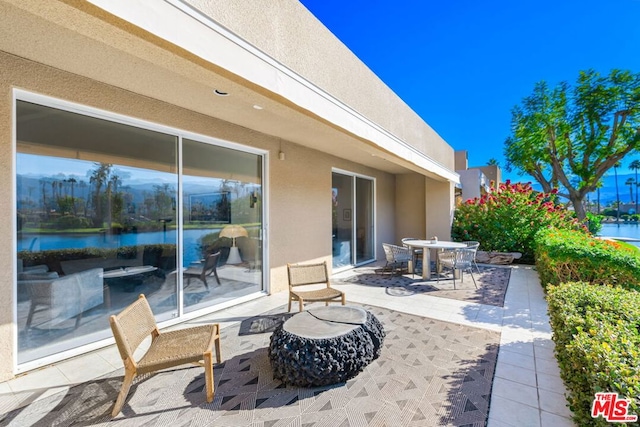 view of patio with a water view