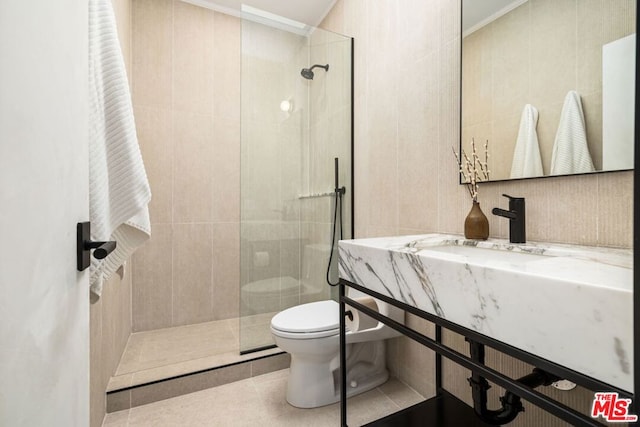 bathroom with sink, tile patterned flooring, toilet, ornamental molding, and a tile shower