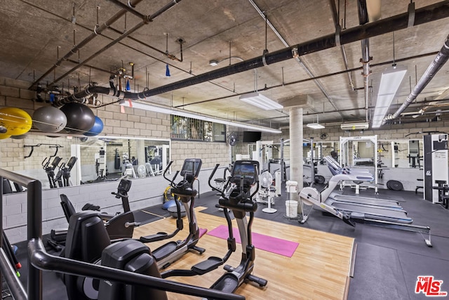 workout area with hardwood / wood-style flooring