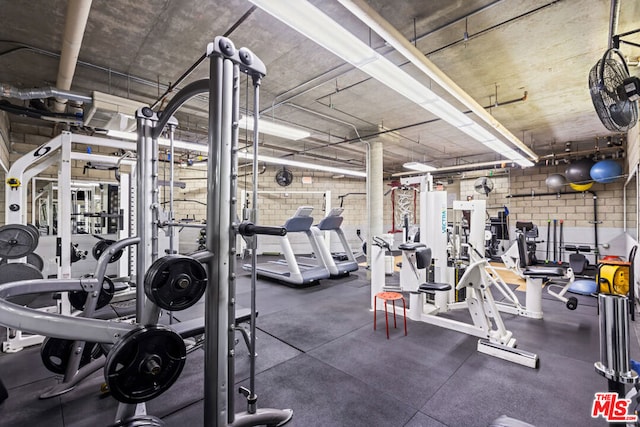 gym featuring brick wall