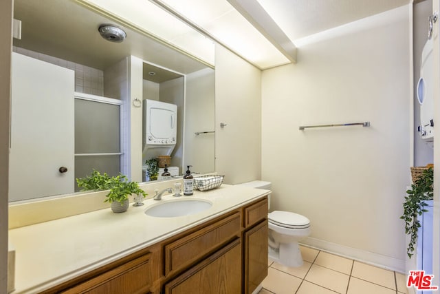 bathroom featuring tile patterned floors, vanity, toilet, and an enclosed shower