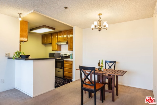 kitchen featuring carpet, pendant lighting, stainless steel electric range, and a notable chandelier