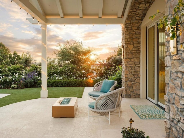 patio terrace at dusk with a yard and a fire pit