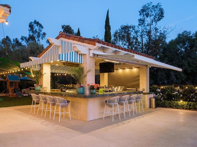 patio terrace at dusk with exterior bar