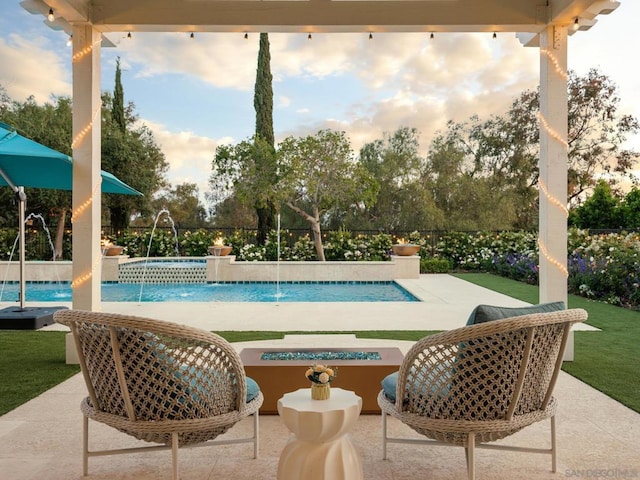 view of swimming pool with pool water feature, a patio, and an in ground hot tub