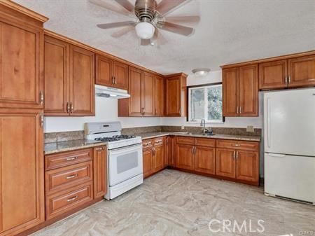 kitchen featuring ceiling fan, sink, and white appliances