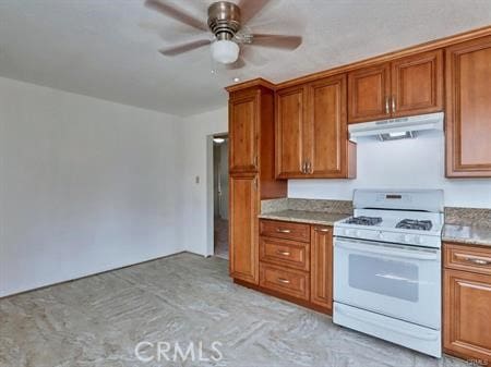 kitchen with ceiling fan and white gas stove