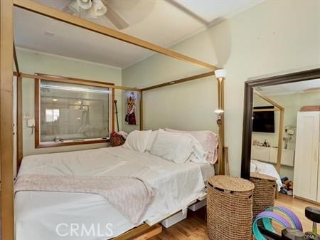 bedroom with ceiling fan and hardwood / wood-style floors