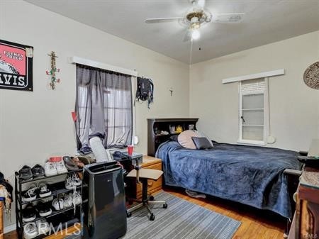 bedroom featuring ceiling fan and wood-type flooring