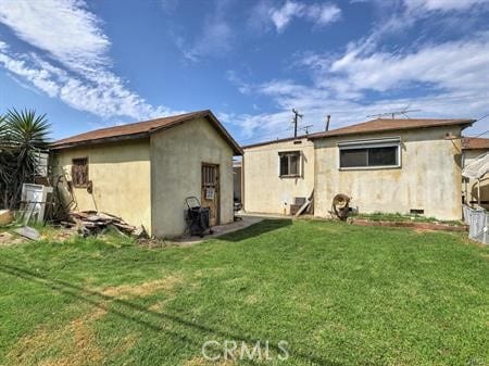 rear view of property with a lawn