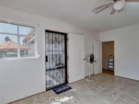 entrance foyer with ceiling fan