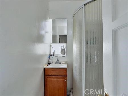 bathroom with walk in shower and vanity