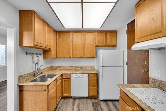 kitchen with light hardwood / wood-style floors, white appliances, and sink