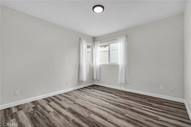 empty room with dark wood-type flooring