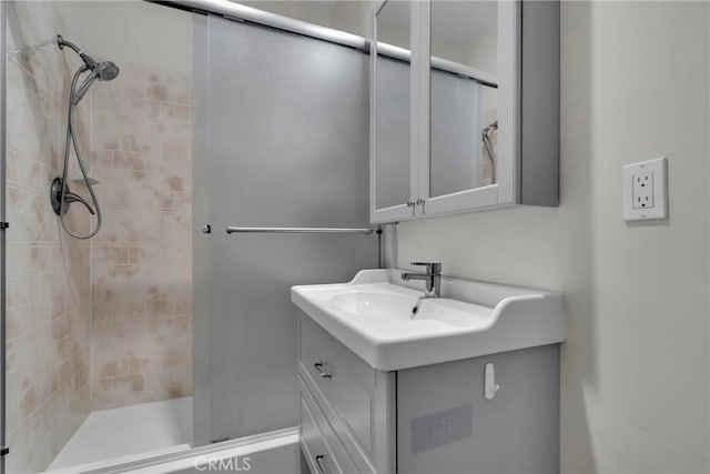 bathroom with vanity and a shower with shower door