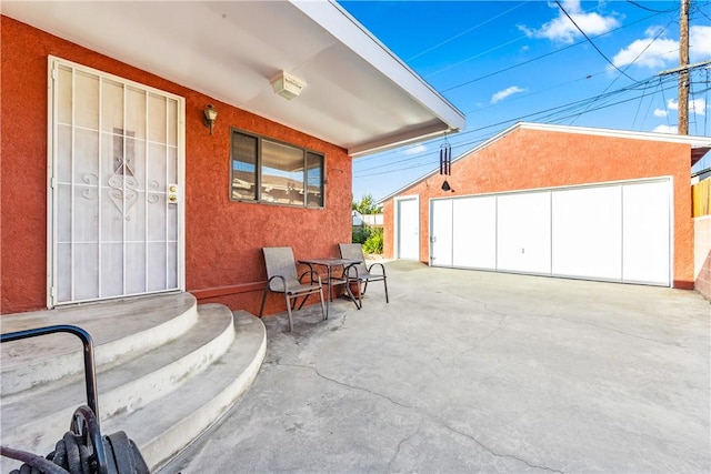 view of patio / terrace featuring a garage and an outdoor structure