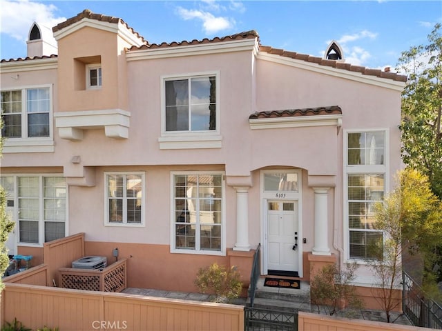 view of front of house featuring a chimney and stucco siding