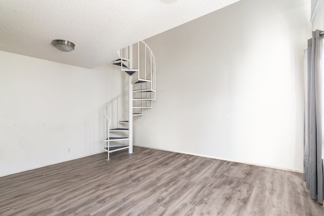 interior space with hardwood / wood-style floors and a textured ceiling