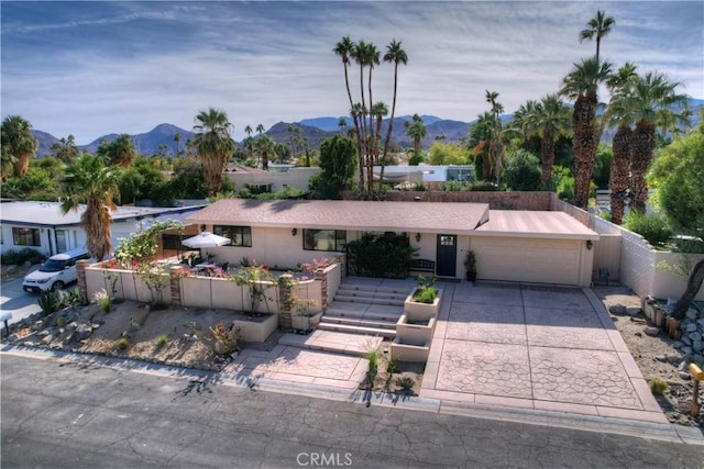 ranch-style house with a mountain view and a garage