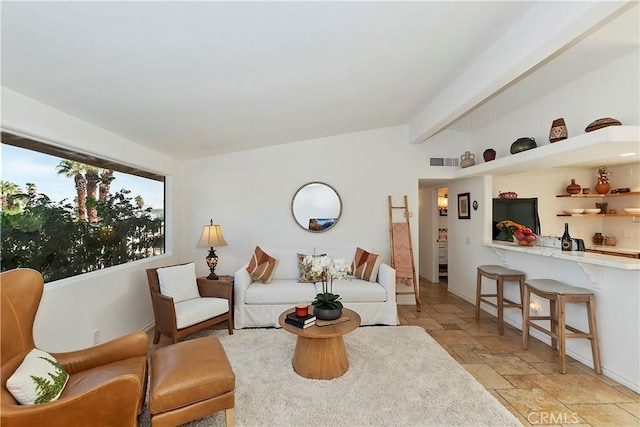 living room featuring beamed ceiling