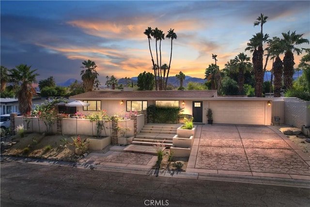 view of front facade featuring a mountain view and a garage