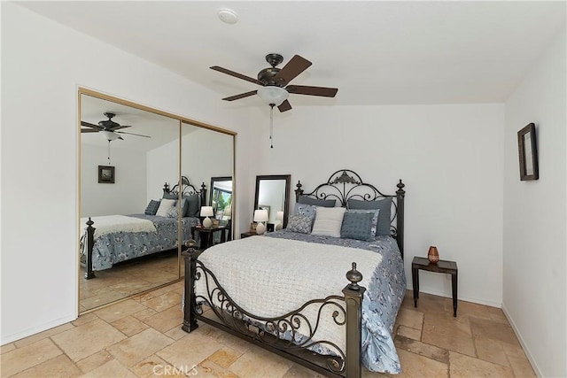 bedroom featuring ceiling fan and a closet