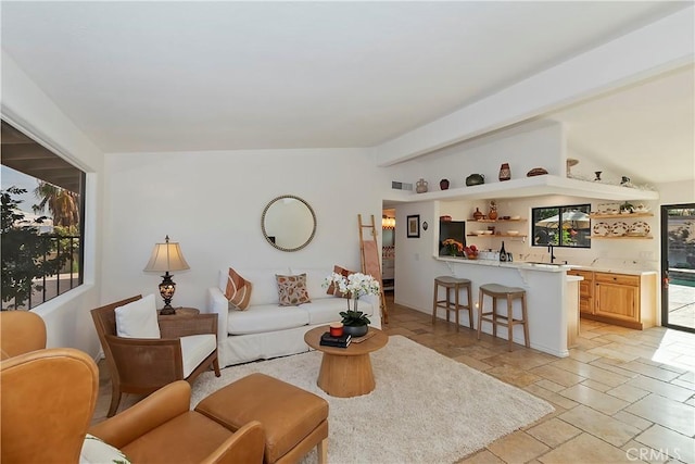 living room with beamed ceiling and indoor bar