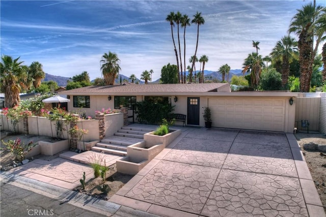 single story home featuring a mountain view and a garage