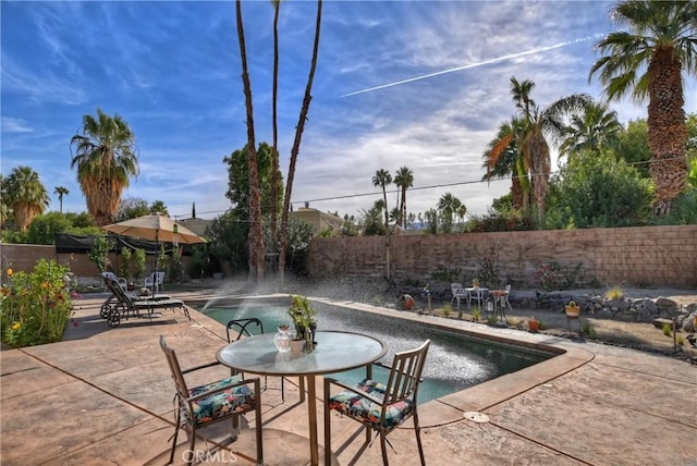 view of swimming pool featuring a patio area