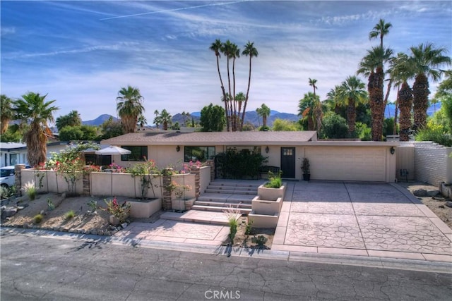 ranch-style home with a mountain view and a garage