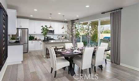 dining area with light hardwood / wood-style flooring