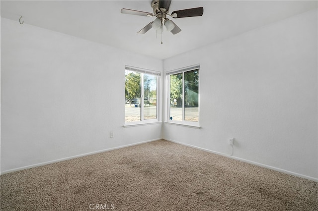 spare room featuring ceiling fan and carpet floors