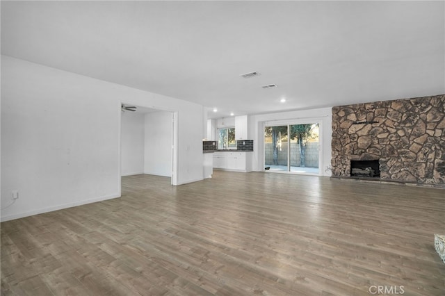 unfurnished living room featuring light hardwood / wood-style floors and a fireplace