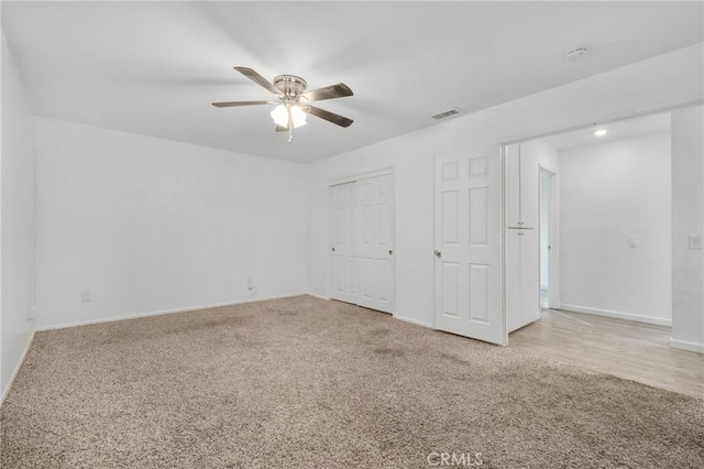 unfurnished bedroom featuring ceiling fan and light colored carpet