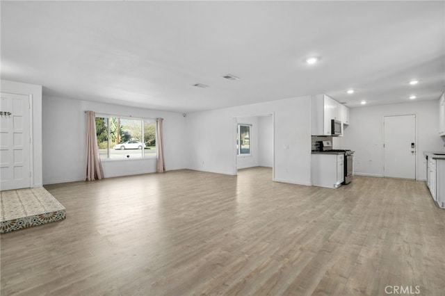 unfurnished living room with light hardwood / wood-style flooring