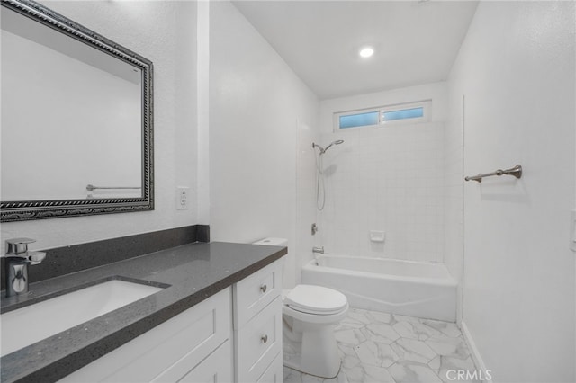 full bathroom with vanity, tiled shower / bath combo, and toilet