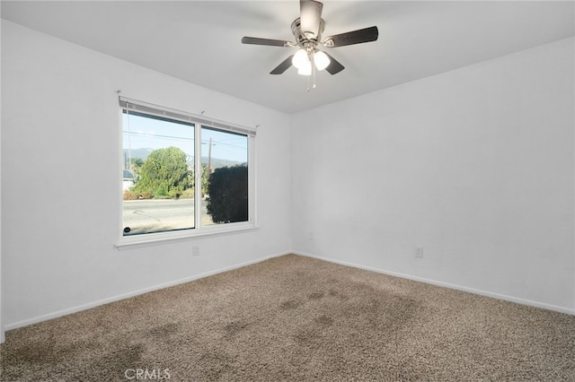 empty room featuring ceiling fan and carpet floors