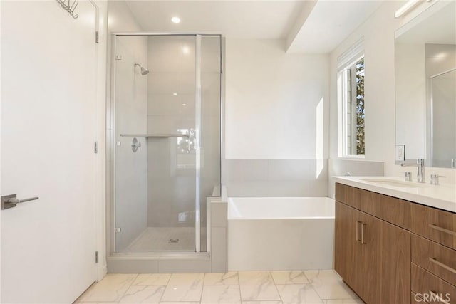 bathroom featuring vanity and separate shower and tub