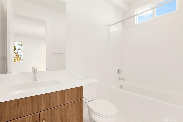 full bathroom featuring vanity, washtub / shower combination, a healthy amount of sunlight, and toilet