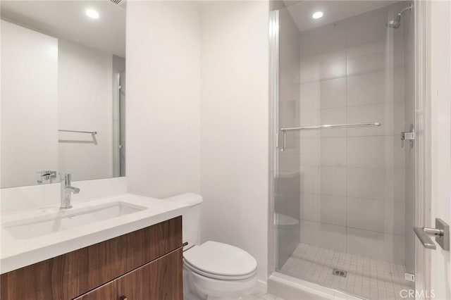 bathroom featuring walk in shower, vanity, and toilet